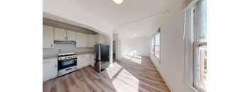 a kitchen with white cabinets and a stove and a refrigerator