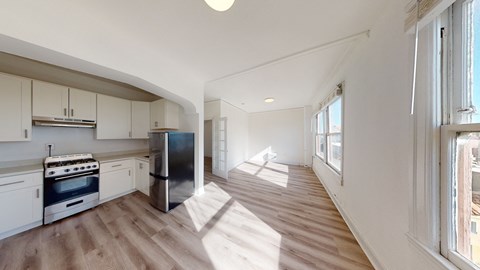 a kitchen with white cabinets and a stove and a refrigerator