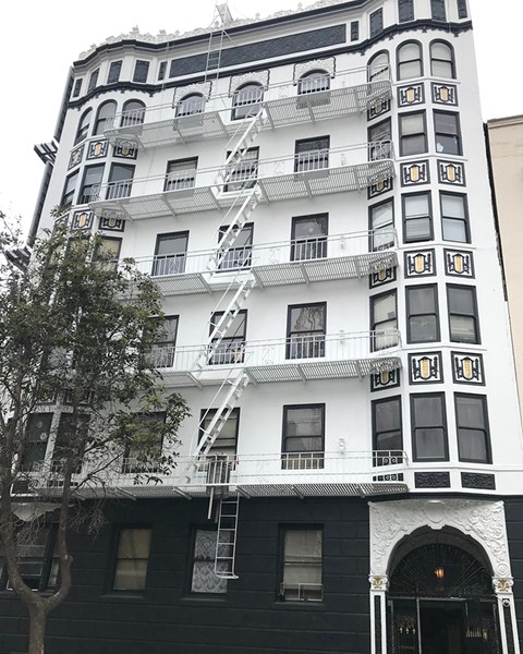a tall building with a fire escape on the side of it