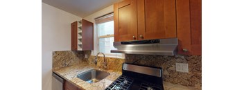 a kitchen with a sink and a stove and a window