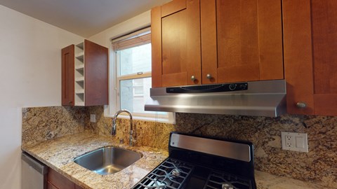 a kitchen with a sink and a stove and a window