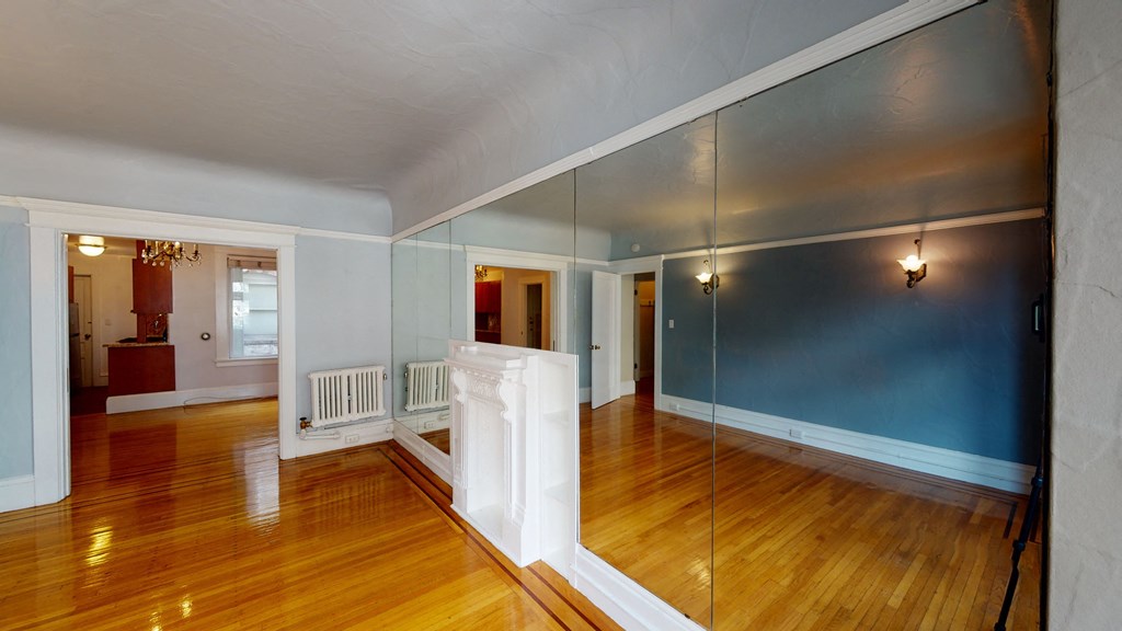 the living room and dining room of an empty house