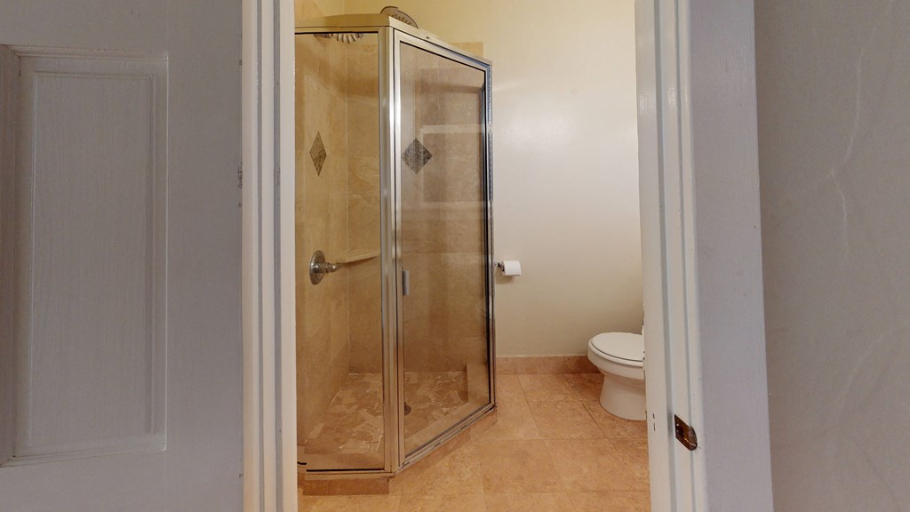 a small bathroom with a shower and a toilet