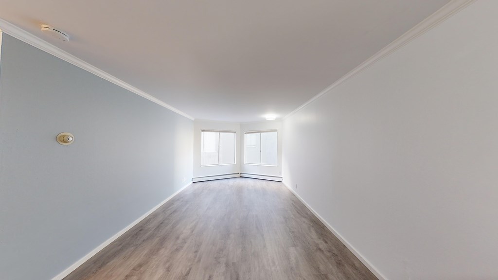 A room with a wooden floor and a window.