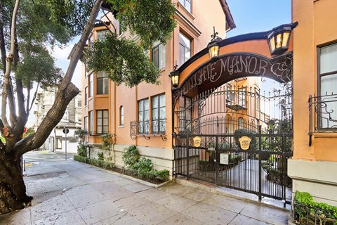 A street view of a building with a sign that reads "The Manor".