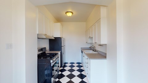 A kitchen with black and white checkered floor.