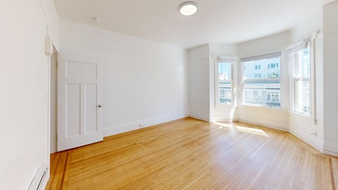 A room with wooden floors and white walls.