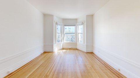A room with wooden floors and white walls.