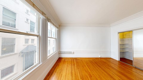 A room with wooden floors and white walls.
