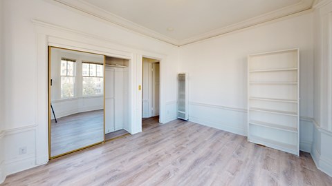 A room with a large mirror on the wall.