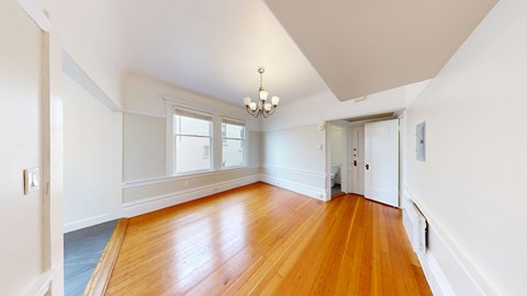 A room with wooden floors and white walls.