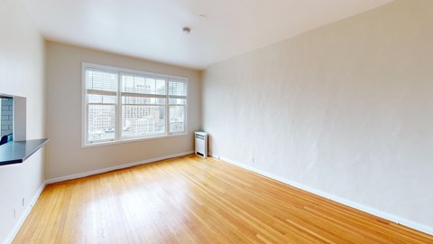 A room with wooden floors and a window.