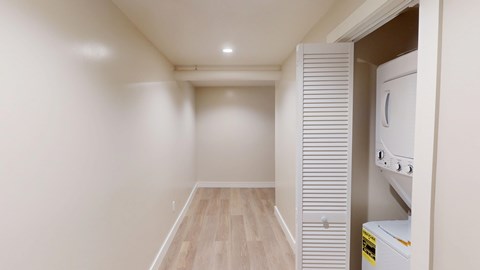 A white kitchen with a fridge and oven.