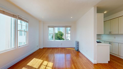 A room with wooden floors and white walls.