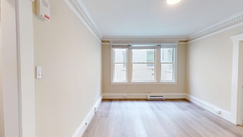 A room with a window and a radiator on the wall.