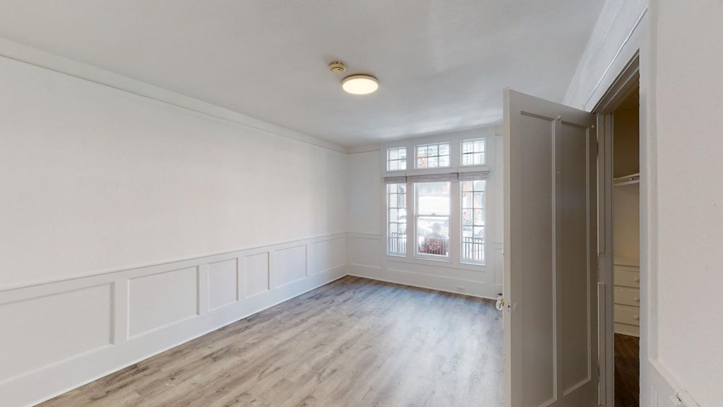 a living room with white walls and a window