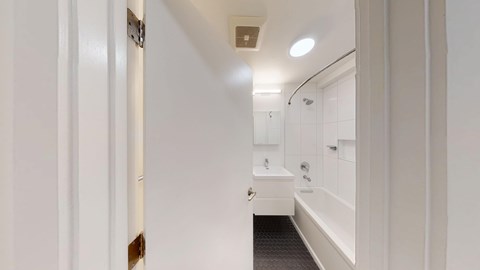 A white bathroom with a walk-in shower and a toilet.