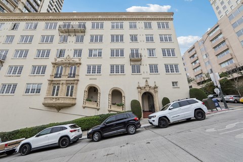 a large building with cars parked in front of it