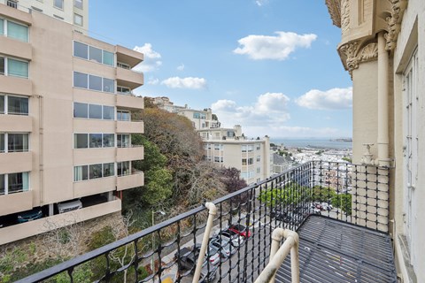 a balcony with a view of the city and the ocean