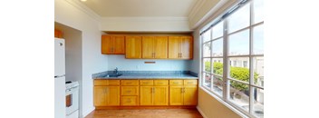 a kitchen with wooden cabinets and a window