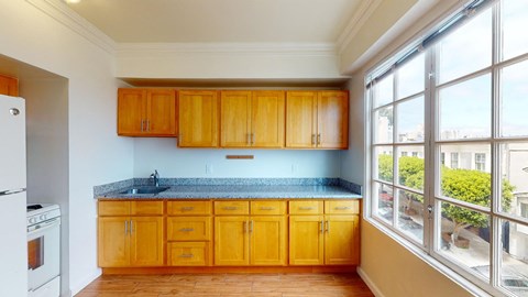 a kitchen with wooden cabinets and a window