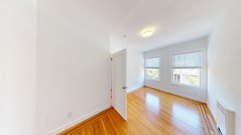 A room with wooden floors and white walls.