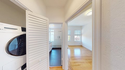 A white kitchen with a black fridge and a white oven.