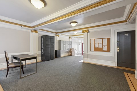 A room with a table and chairs and a black door.