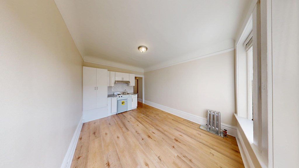 A room with wooden floors and white walls.