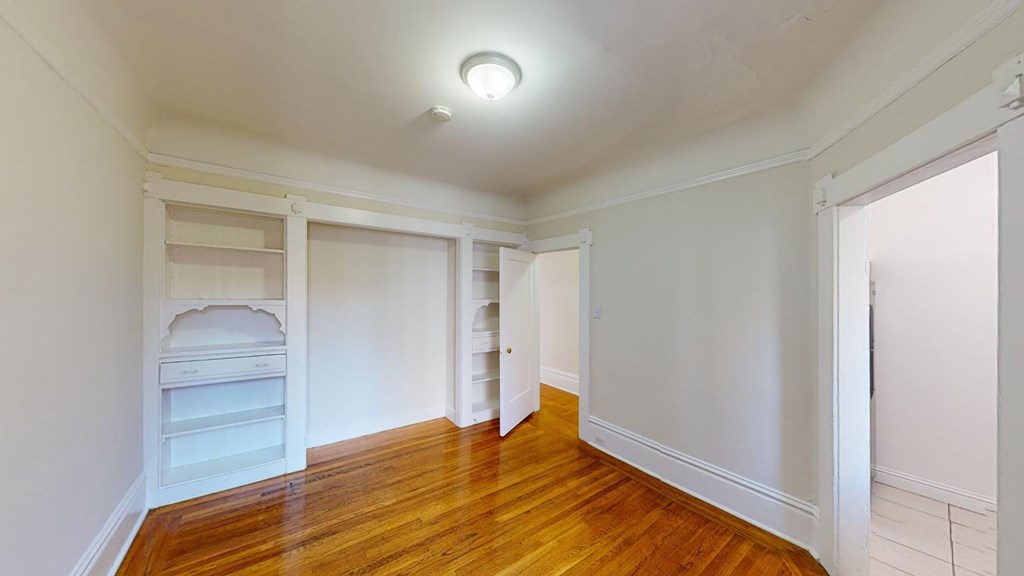 A room with wooden floors and white walls.