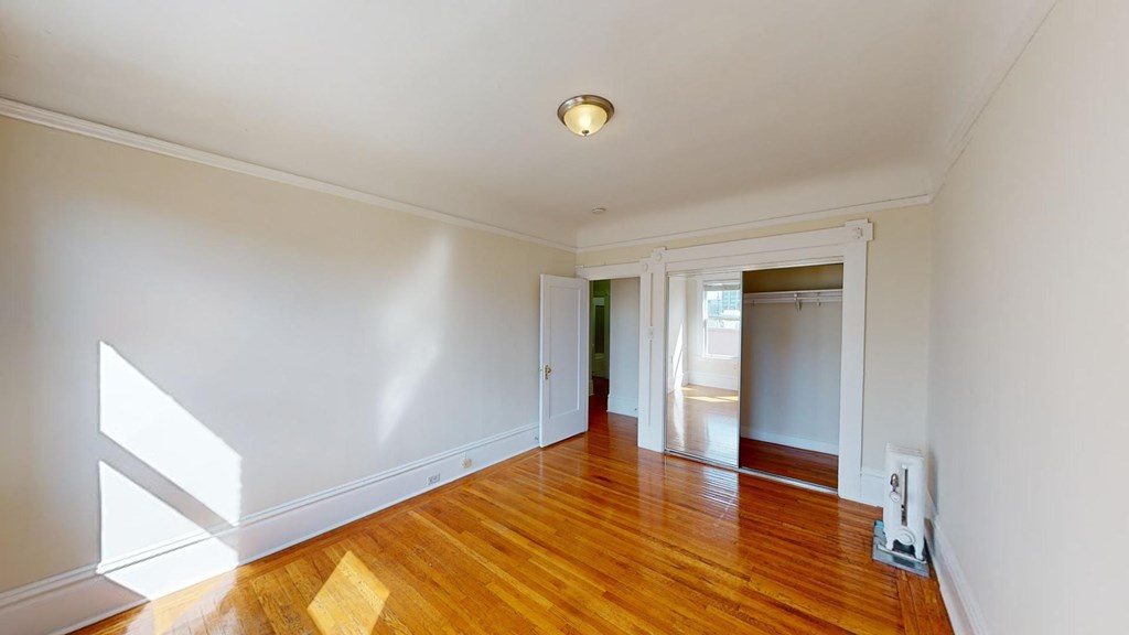 A room with wooden floors and white walls.