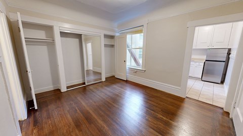 A room with wooden floors and white walls.