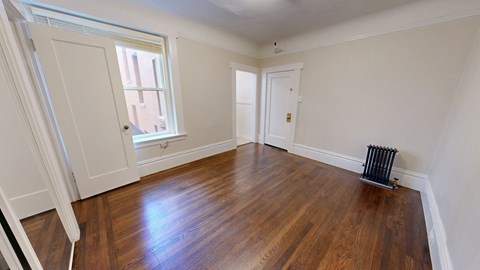 A room with wooden floors and white walls.