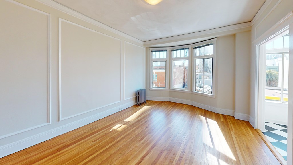 A room with wooden floors and white walls.