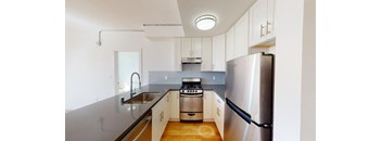 a kitchen with stainless steel appliances and white cabinets