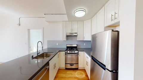 a kitchen with stainless steel appliances and white cabinets