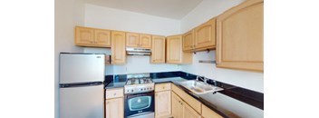 a kitchen with wooden cabinets and a stove and refrigerator