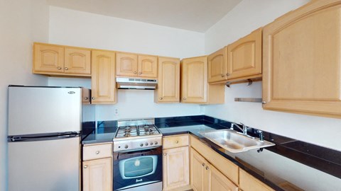 a kitchen with wooden cabinets and a stove and refrigerator