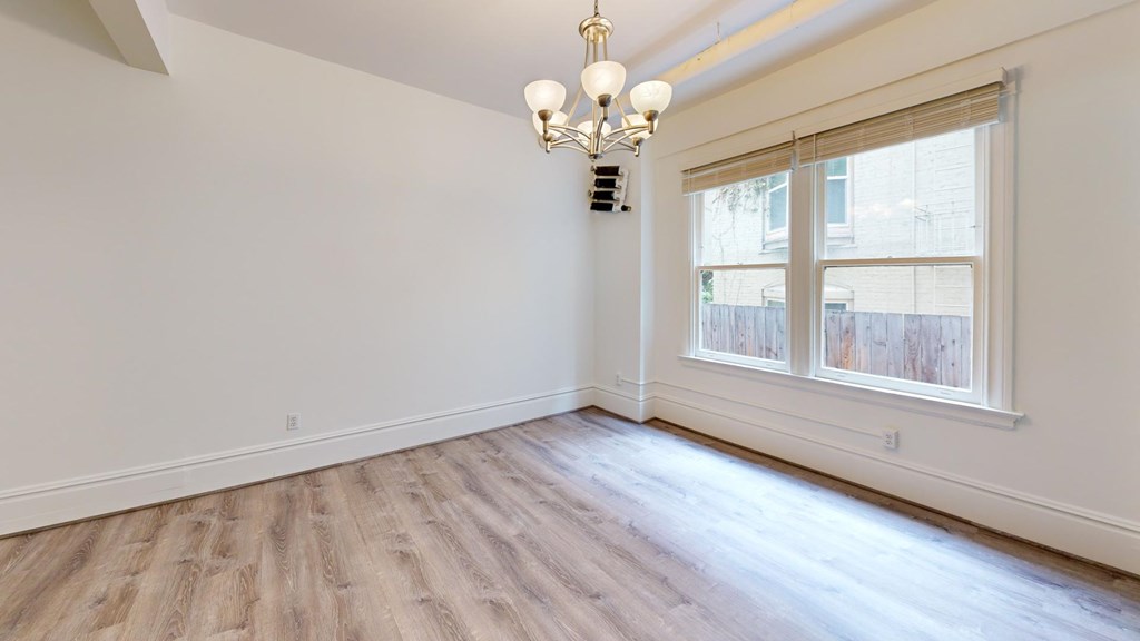 A room with a window and a chandelier.