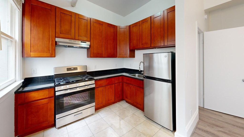 A kitchen with wooden cabinets and stainless steel appliances.
