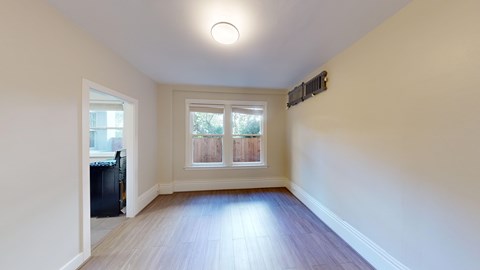 A room with a window and a door.