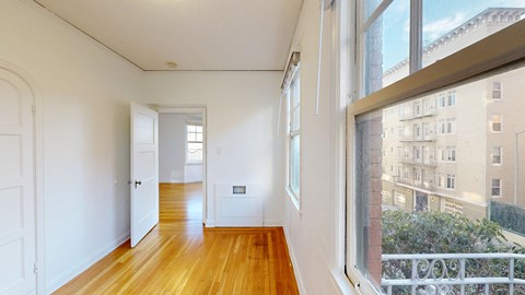 A room with wooden floors and white walls.
