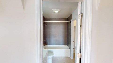 A white bathroom with a walk-in shower.
