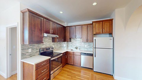 A kitchen with wooden cabinets and a white countertop.