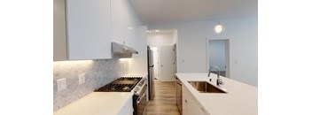 a kitchen with white counter tops and a sink