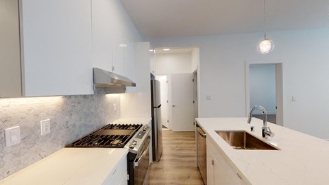 a kitchen with white counter tops and a sink