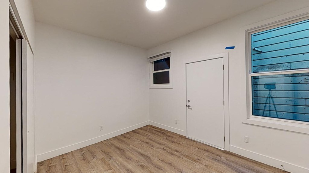 a bedroom with a door and a window