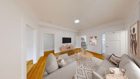 A living room with a grey couch and a coffee table.