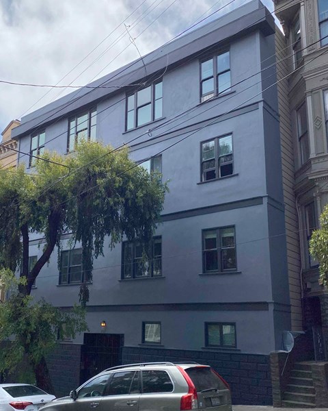 a white building with cars parked in front of it