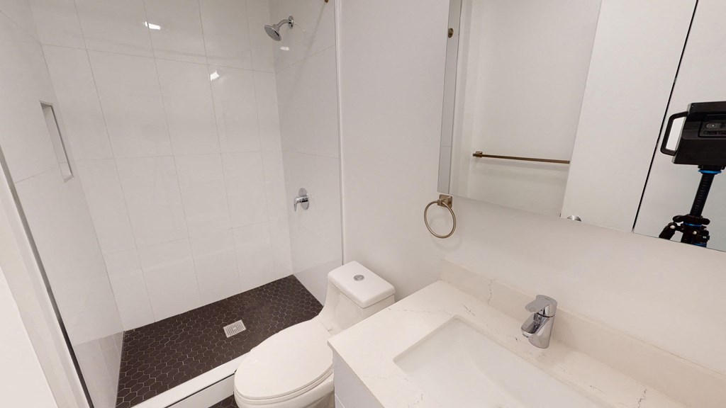 a white bathroom with a white toilet and sink